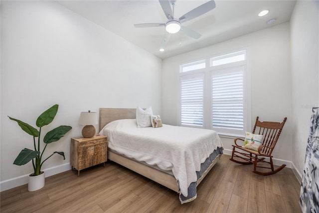 bedroom with ceiling fan and light hardwood / wood-style floors