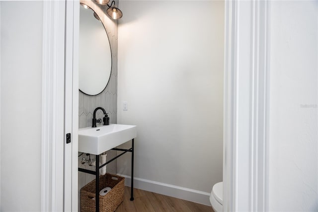 bathroom featuring sink, toilet, and hardwood / wood-style floors