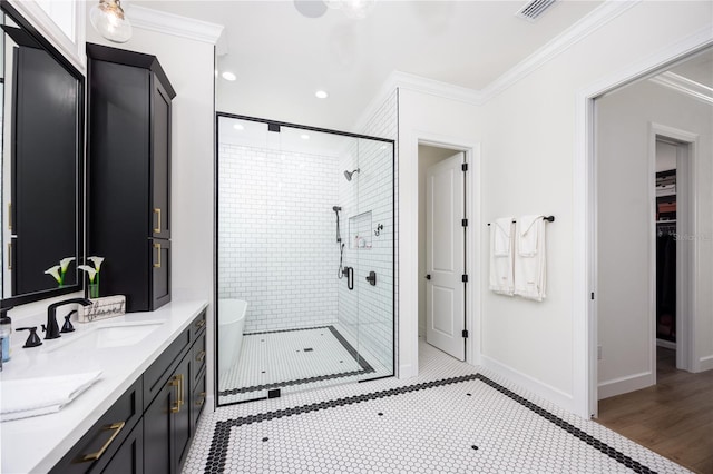 bathroom with vanity, an enclosed shower, crown molding, and hardwood / wood-style floors