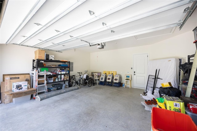 garage with a garage door opener and electric panel