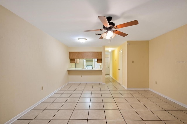 unfurnished living room featuring ceiling fan and light tile patterned floors