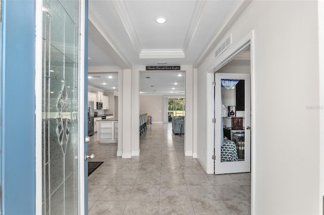 tiled entrance foyer featuring a tray ceiling