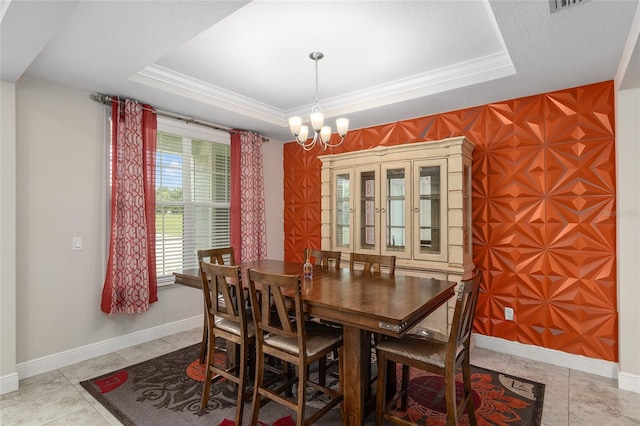 tiled dining room with a notable chandelier and a raised ceiling