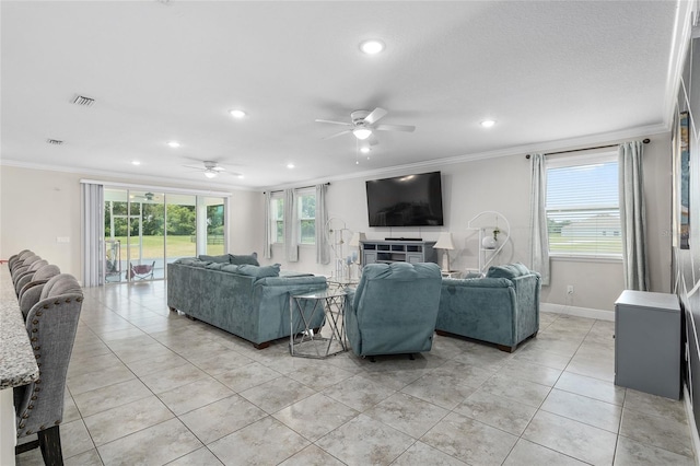 living room with light tile patterned flooring, crown molding, and ceiling fan