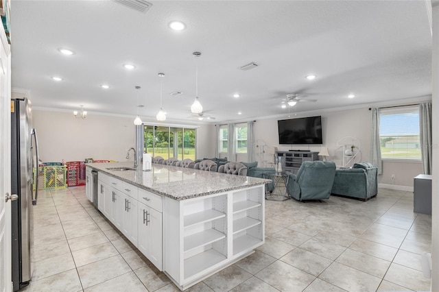 kitchen featuring sink, crown molding, an island with sink, white cabinetry, and ceiling fan