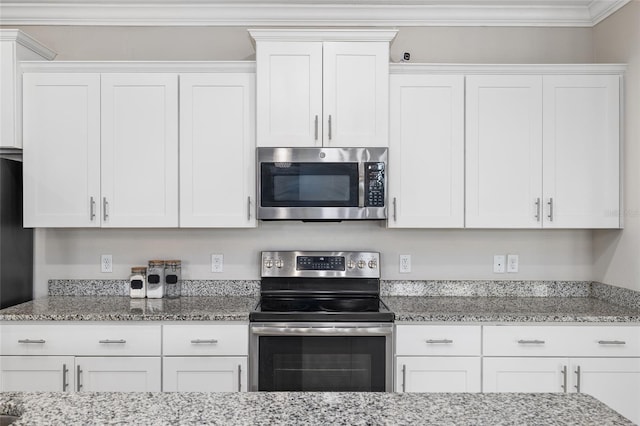 kitchen featuring appliances with stainless steel finishes, crown molding, light stone counters, and white cabinetry