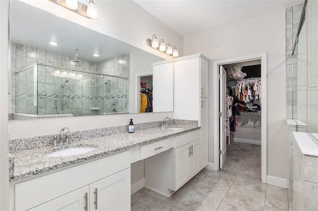 bathroom with double vanity, walk in shower, and tile patterned flooring