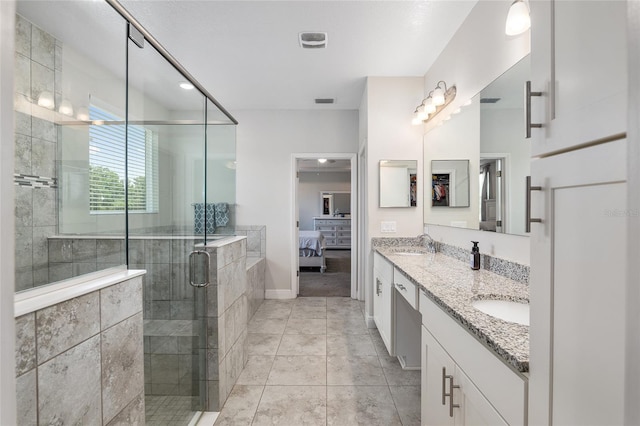 bathroom featuring dual vanity, tile patterned floors, and a shower with door