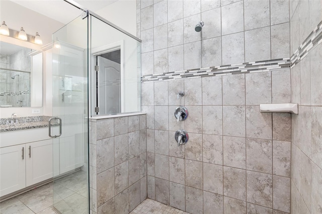 bathroom with vanity, an enclosed shower, and tile patterned flooring