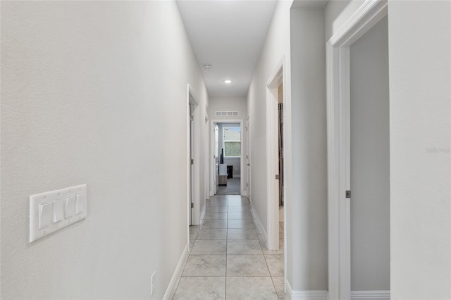 hall with light tile patterned floors