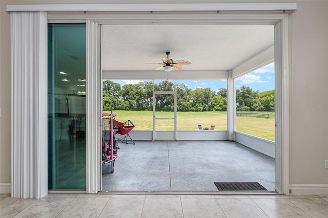 unfurnished sunroom with a wealth of natural light and ceiling fan