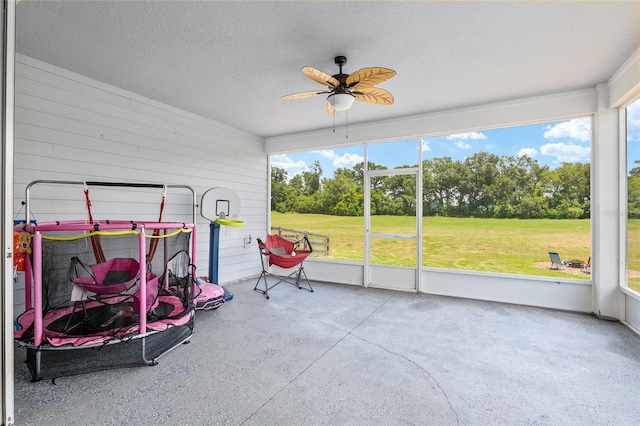 sunroom with a wealth of natural light and ceiling fan