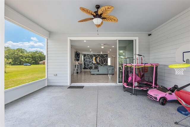 sunroom featuring ceiling fan