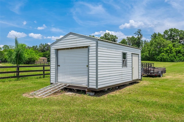 view of outbuilding with a yard