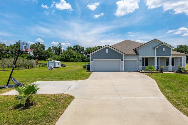 view of front of property featuring a garage, a storage unit, and a front lawn