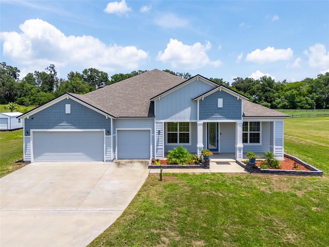 view of front of property featuring a garage and a front lawn