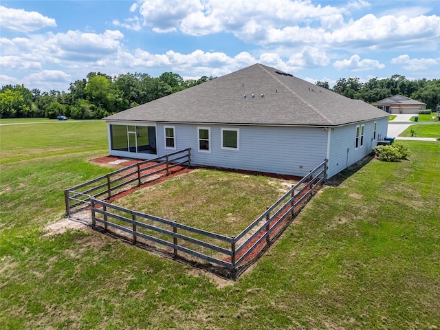 back of property with a lawn