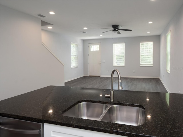 kitchen featuring ceiling fan, wood-type flooring, sink, and dark stone countertops