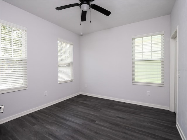 empty room featuring dark hardwood / wood-style flooring and a healthy amount of sunlight