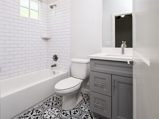 full bathroom with toilet, tiled shower / bath, vanity, and tile patterned flooring