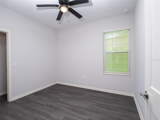 empty room featuring ceiling fan and dark hardwood / wood-style floors