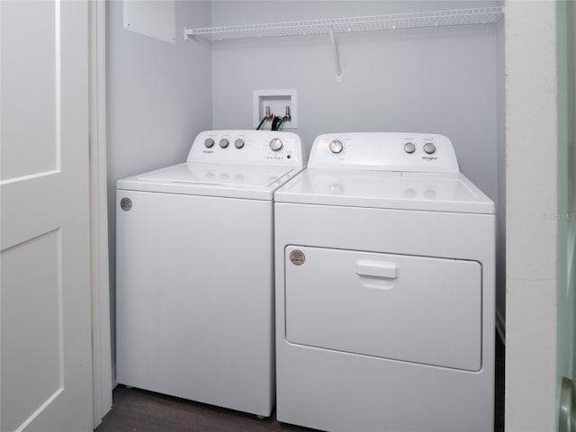 washroom with washing machine and dryer and dark wood-type flooring