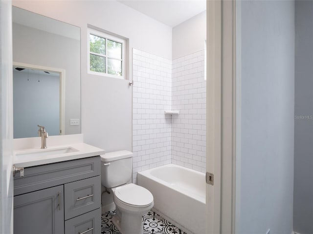 full bathroom with toilet, tiled shower / bath combo, vanity, and tile patterned flooring