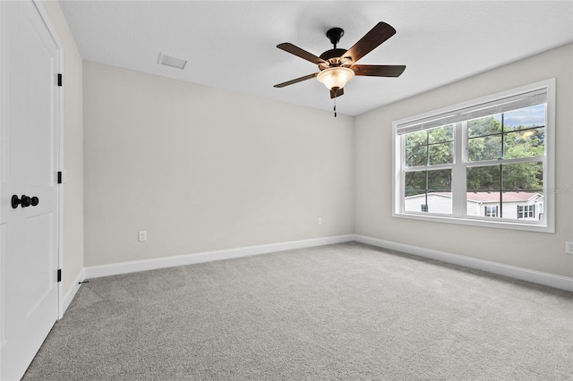 spare room featuring light carpet and ceiling fan