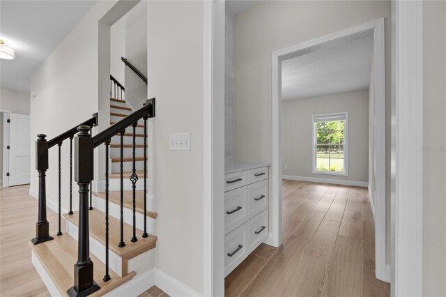 stairway featuring light hardwood / wood-style flooring