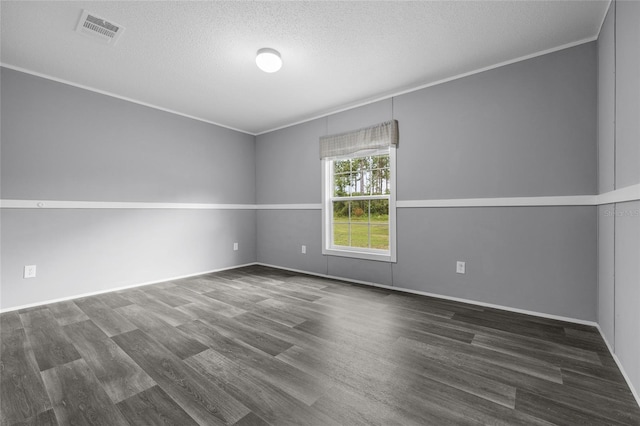 unfurnished room with a textured ceiling, hardwood / wood-style flooring, and ornamental molding