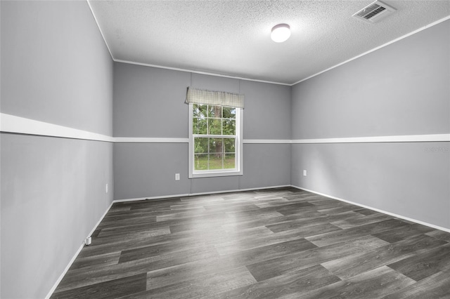 empty room featuring wood-type flooring, ornamental molding, and a textured ceiling