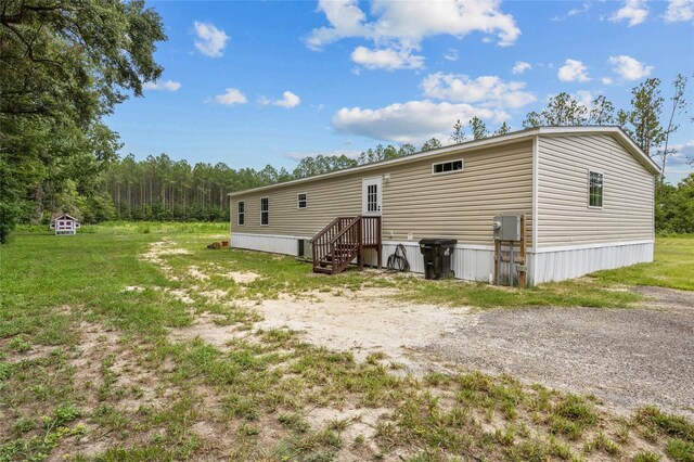 rear view of property with a lawn