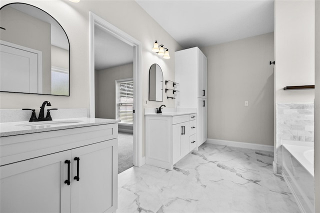 bathroom with tile patterned floors, a bathing tub, and double vanity