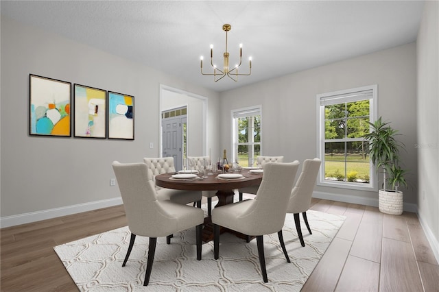 dining room featuring hardwood / wood-style flooring and a notable chandelier