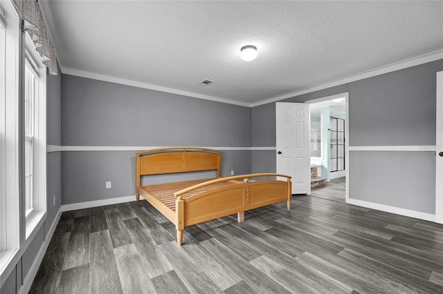 bedroom featuring ornamental molding, a textured ceiling, and hardwood / wood-style floors