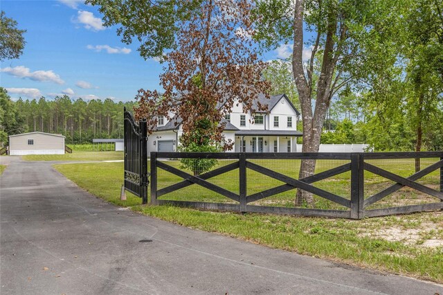 view of gate featuring a lawn