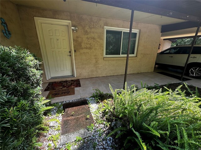 4215 NW 10th St, Gainesville, FL 32609 - doorway to property featuring stucco siding