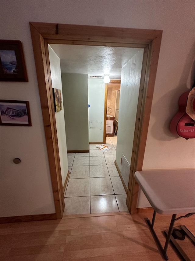 corridor featuring light tile patterned floors