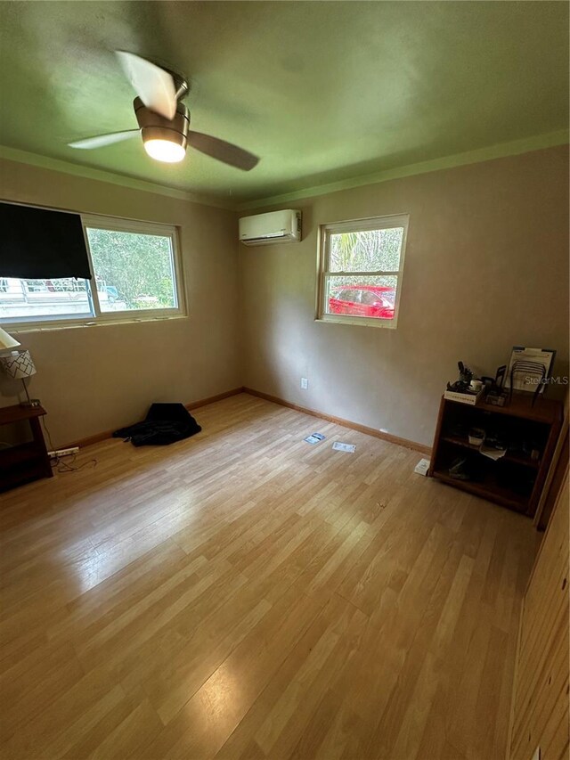 4215 NW 10th St, Gainesville, FL 32609 - spare room with plenty of natural light, crown molding, an AC wall unit, light wood-style floors, and a ceiling fan