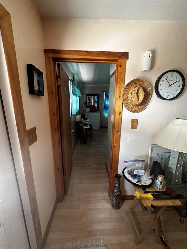 hallway with light hardwood / wood-style flooring