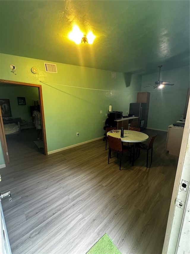 dining room with hardwood / wood-style floors and ceiling fan