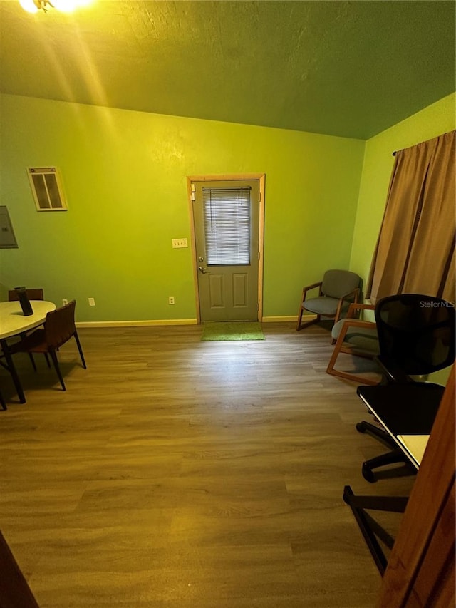 home office with hardwood / wood-style floors and a textured ceiling