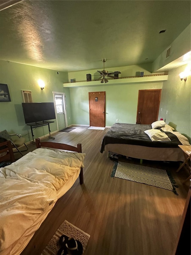 bedroom with wood-type flooring and ceiling fan