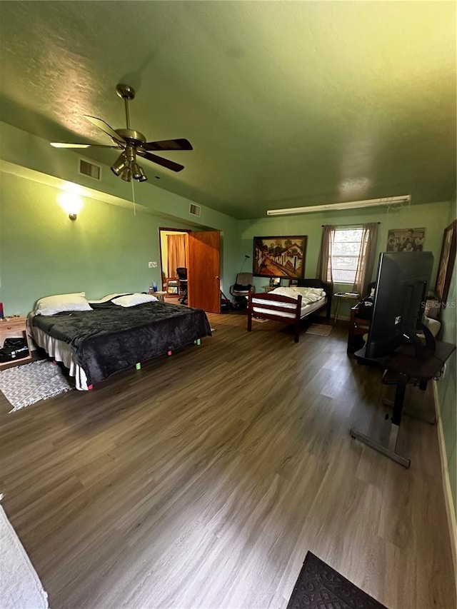 bedroom with hardwood / wood-style floors and ceiling fan