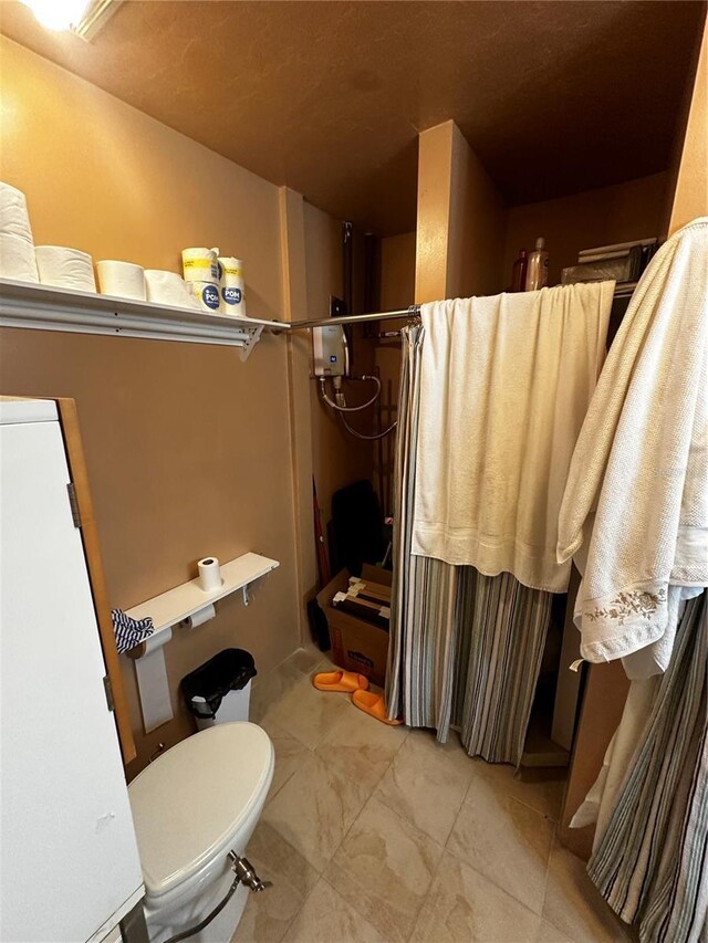4215 NW 10th St, Gainesville, FL 32609 - bathroom featuring curtained shower and toilet