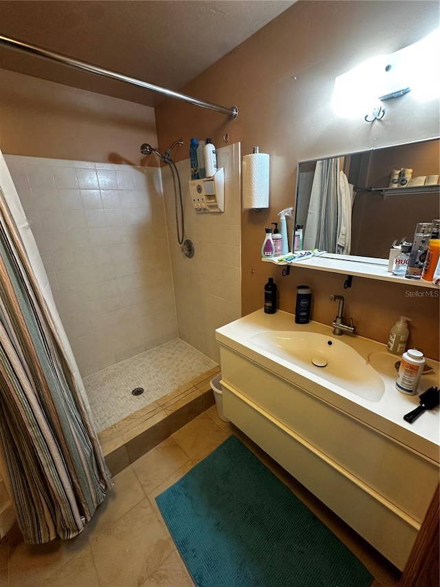 bathroom with tile patterned flooring, vanity, toilet, and walk in shower