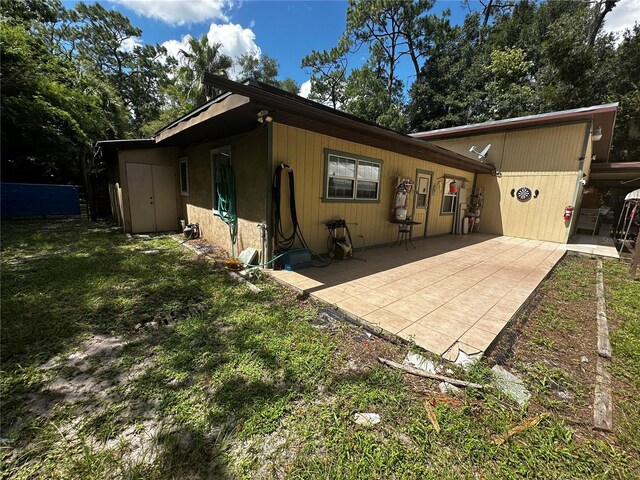 4215 NW 10th St, Gainesville, FL 32609 - rear view of house with a patio and a yard