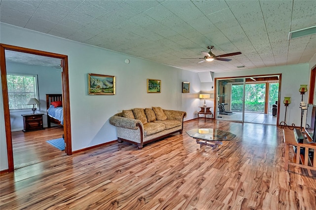 living room featuring light wood-type flooring and ceiling fan