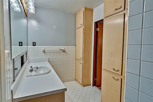 bathroom featuring tile patterned flooring, vanity, and tile walls