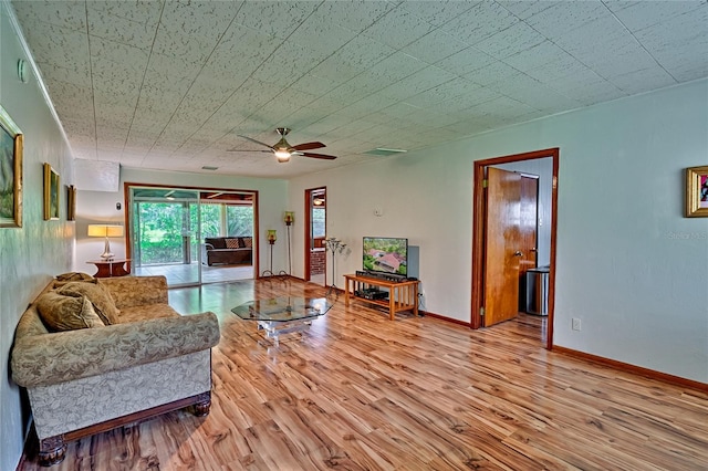 living room featuring ceiling fan and light hardwood / wood-style flooring